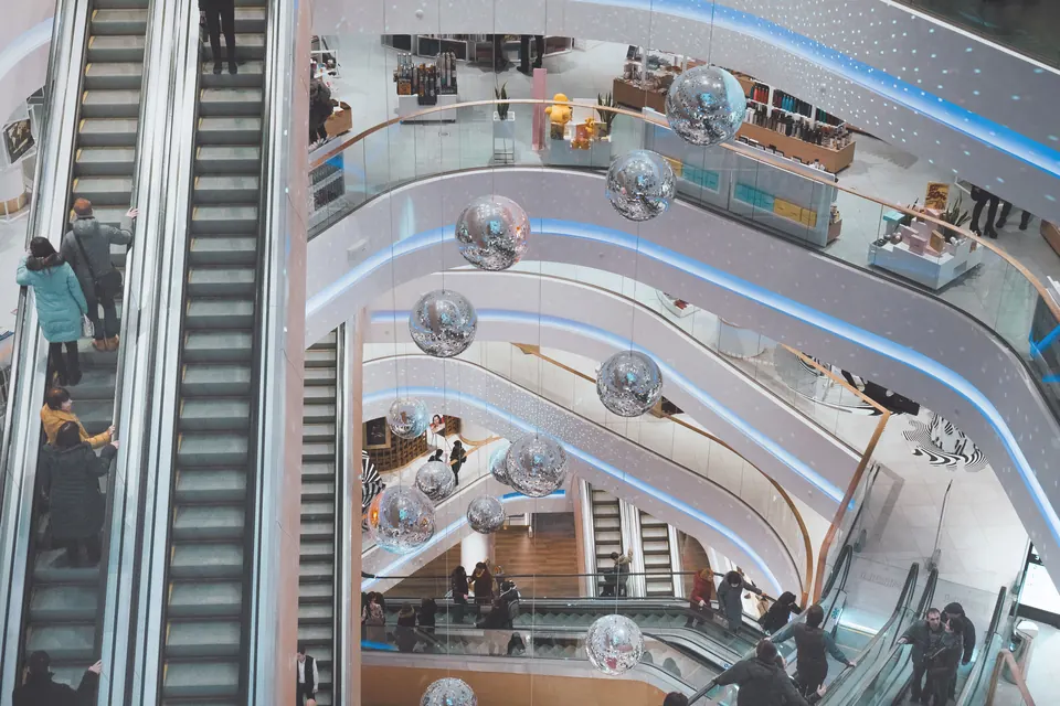 Shopping mall atrium with escalators and lighting